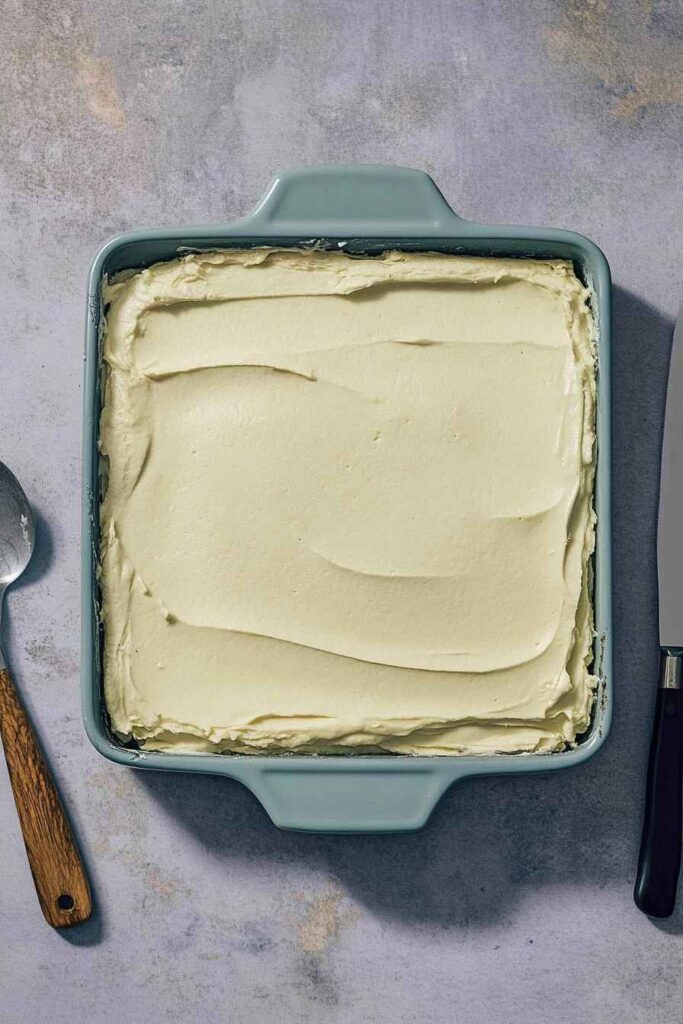 Pistachio Tiramisu – Creamy, Nutty, and No-Bake Delight 4 Pistachio tiramisu layered in a baking dish with smooth mascarpone cream spread evenly on top.