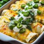 Cheesy Chicken Enchiladas Salsa Verde topped with sour cream, jalapeños, and fresh cilantro.