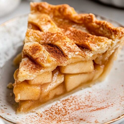 Sugar Free Apple Pie – Naturally Sweet Apple Pie Recipe 5 Slice of sugar free apple pie topped with cinnamon on a ceramic dessert plate